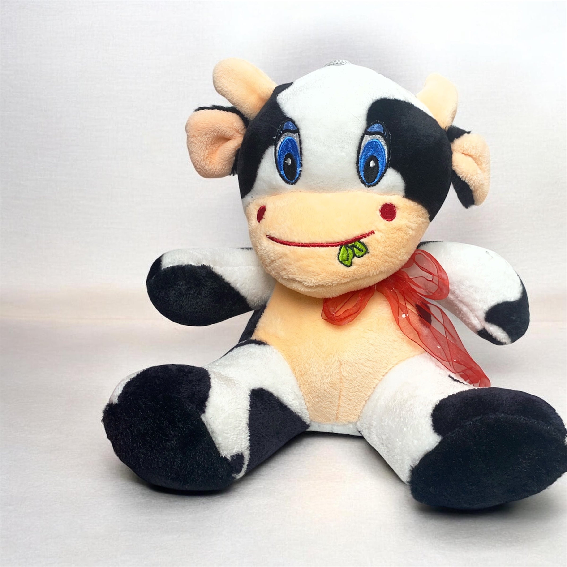 Cute Spotted Cow Plush Toy – Seated Stuffed Animal with Blue Eyes and Red Ribbon Bow